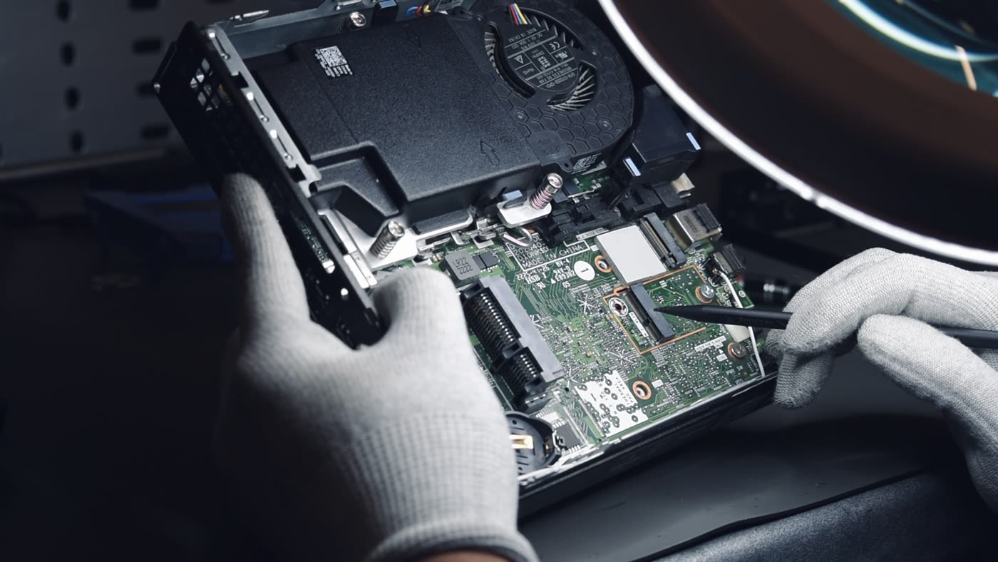 A Greensafe engineer working on a device mainboard